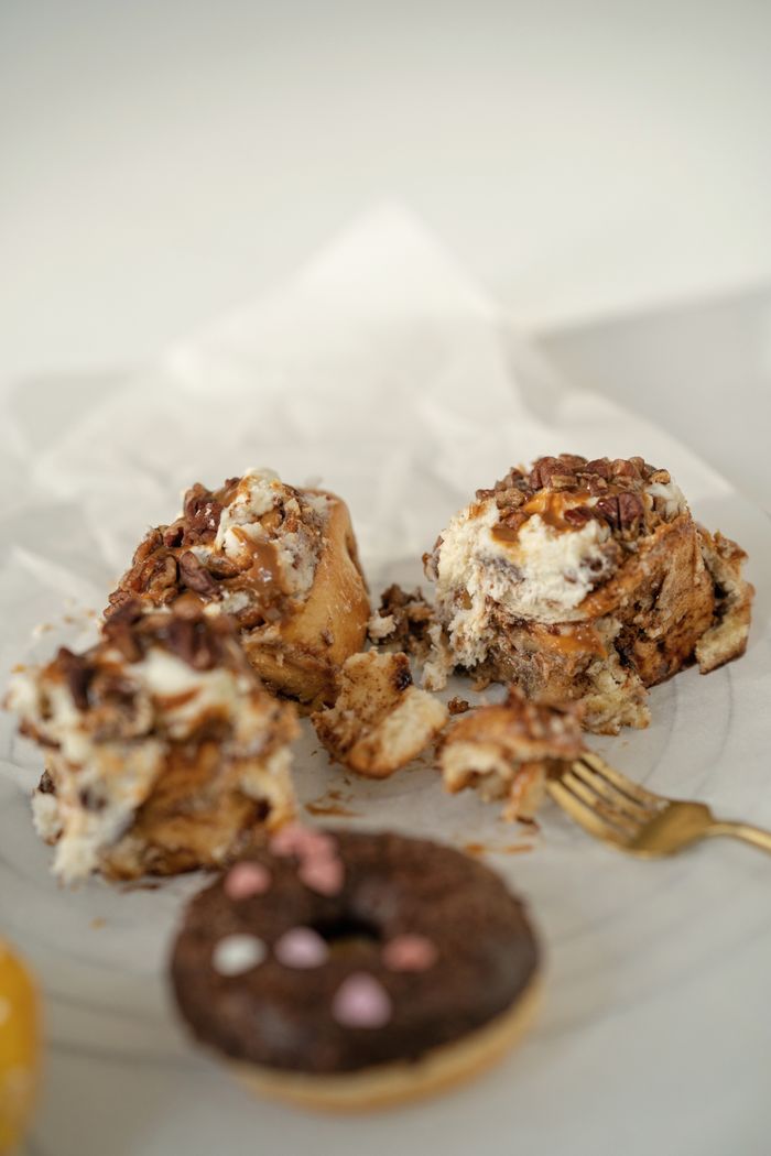 A close-up view of delectable cinnamon rolls topped with creamy icing, perfect for dessert lovers.