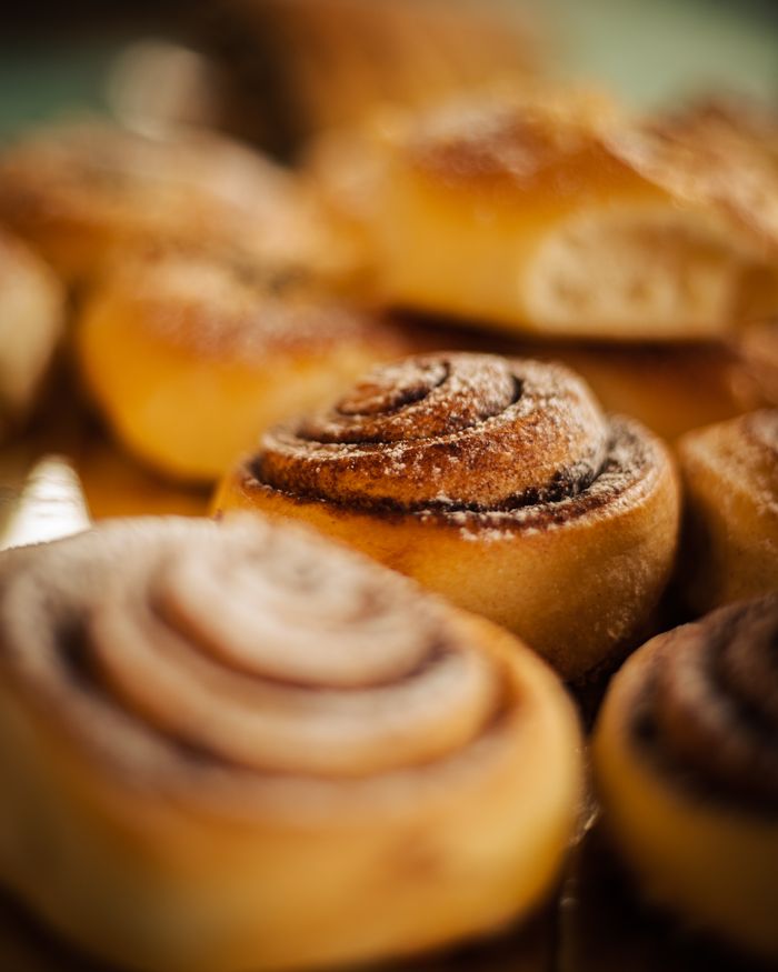 Close-up of delicious cinnamon rolls in a bakery, showcasing texture and sweetness.